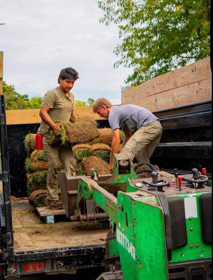 The DR Property Services crew unloading rolls of sod for a landscaping job